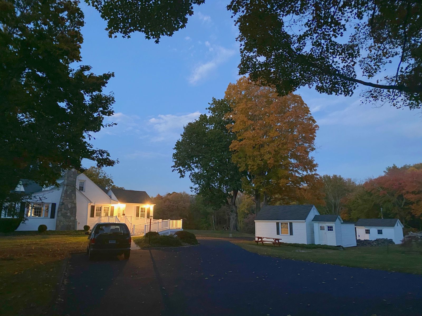The farmhouse porch lit at dusk